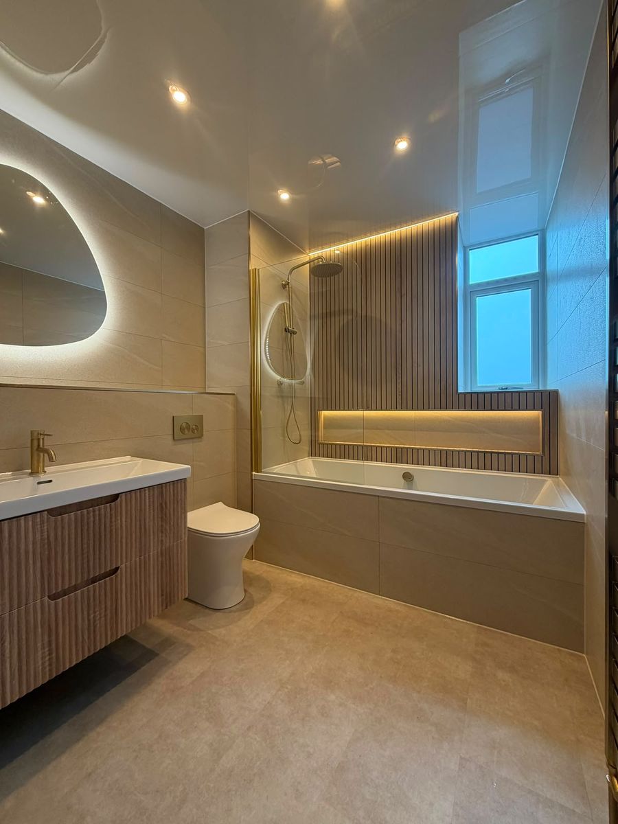 Full bathroom renovation with freestanding fluted bath and panelled wall